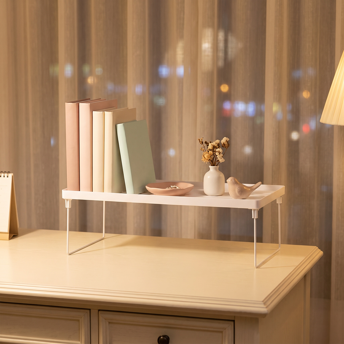 Desktop storage shelf on a cream desk