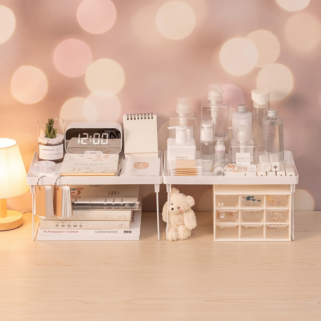 Desktop storage shelf beside a glowing lamp